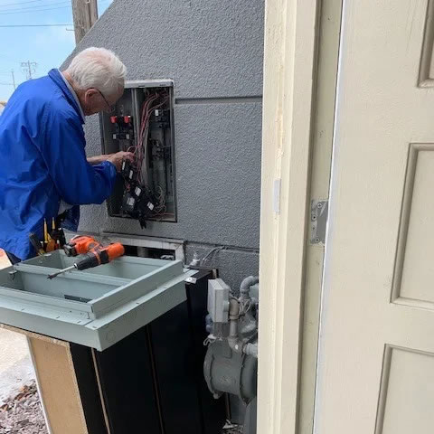 Electrician installing an AFCI breaker in a San Francisco panel